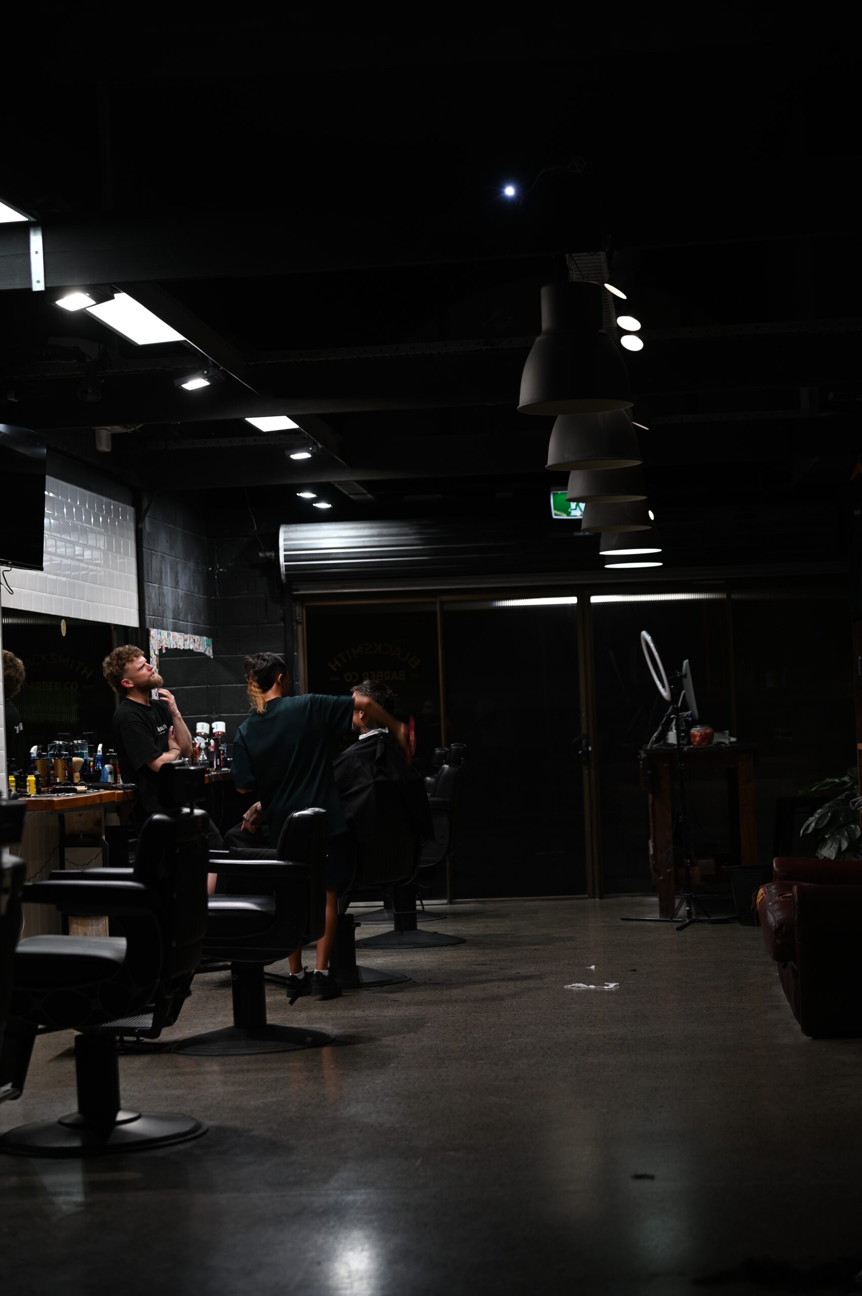 The Blacksmith warehouse floor with barbers at work